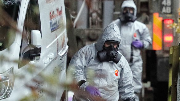 Military agents work on a van in Winterslow, England, on Monday, in connection with the spy case.
