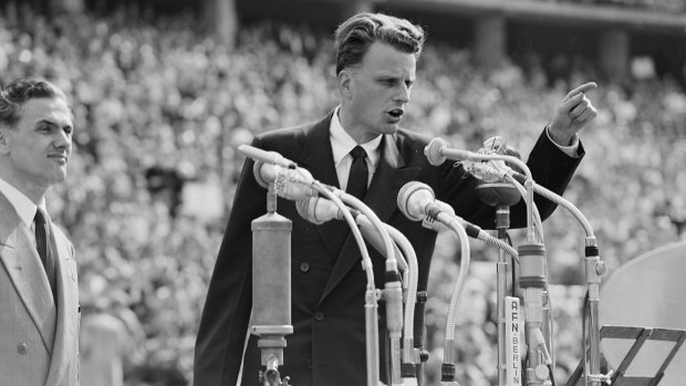 Evangelist Billy Graham speaks to over 100,000 Berliners at the Olympic Stadium in Berlin in 1954.