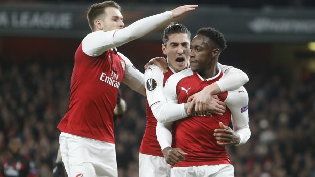 Moving on: Danny Welbeck, right, celebrates with his teammates Aaron Ramsey, left, and Hector Bellerin after scoring his side's opening goal. 