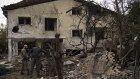 Members of the Israeli forces inspect a site following a rocket fired from Lebanon hit an area in Rinatya, outskirts of Tel Aviv on Sunday,.