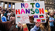 Students hold signs protesting Pauline Hanson in Melbourne.