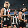 The Magpies look dejected after losing the round one AFL match against the Sydney Swans at the MCG.