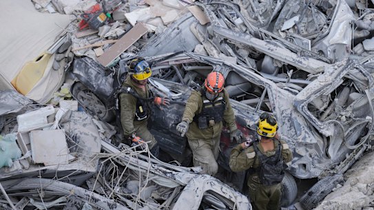 Israeli soldiers dig through rubble to search for survivors in a residential area hit by a missile fired from Iran, near Tel Aviv, Israel, Sunday,