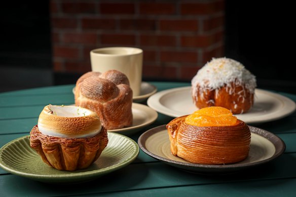 Pastries at Daybaker, clockwise from front left: lemon meringue tart, morning bun, bomba Calabrese and a round pastry filled with blood orange cream, lemon financier and mandarin segments