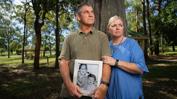 Paul and Linda Grimmer pose for photos with a framed photograph of Paul and his younger sister Cheryl in the 1970s.