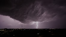 Lightning flashes as a thunderstorm passes in the distance Monday, April 13, 2026, in Lenexa, Kansas.