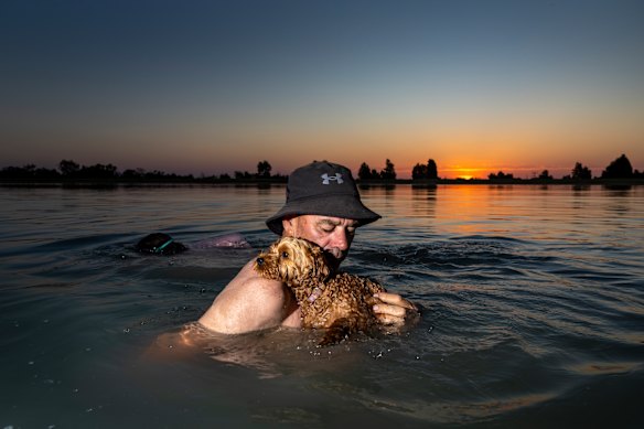 Andrew Lanigan and his dog Maggie  cool down in the lake at Ouyen, where the temperature approached 49 degrees this week.