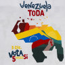 A woman sells fruit in front of a mural of the Venezuelan map with the Essequibo territory included and the words “All of Venezuela. Vote yes five time on December 3”, in Caracas.