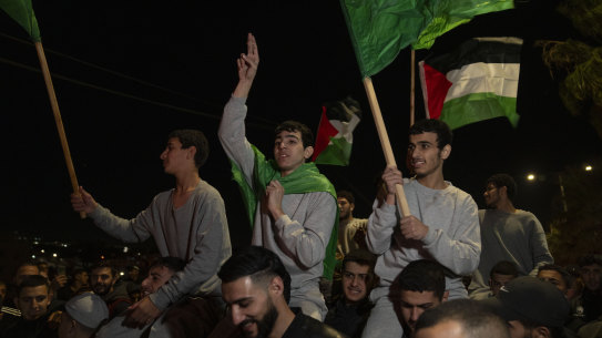 Former Palestinian prisoners who were released by Israeli authorities fly Palestinian and Hamas flags.