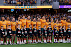 The Wallabies stand for the national anthem.