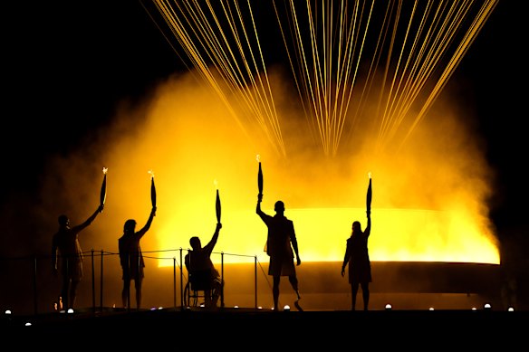 Torchbearers Charles Antoine Kouakou, Fabien Lamirault, Elodie Lorandi, Nantenin Keita and Alexis Hanquinquant gesture after lighting the Cauldron to conclude the opening ceremony of the Paris 2024 Summer Paralympic Games at Place de la Concorde in Paris, France.