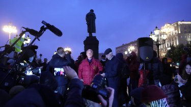 Russian Communistâs party candidate Valery Rashkin, center, speaks to the media as he arrives for a protest against the results of the Parliamentary election in Moscow, Russia in September.