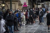 Long lines of people wanting to get vaccinated against COVID-19 are seen at Melbourne Town Hall on Friday.