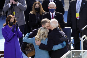 Joe Biden hugs first lady Jill Biden,  son Hunter and daughter Ashley after his swearing-in as Kamala Harris looks on. 