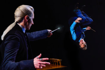 Draco Malfoy (Lachlan Woods) turns Harry Potter (Gareth Reeves) upside down during a wizarding duel in the Princess Theatre production of Harry Potter and the Cursed Child.
