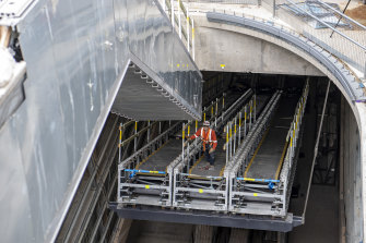 A worker helps install the escalators at Central Station.