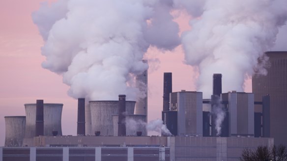 Steam rises from cooling towers of a German coal-fired power plant.