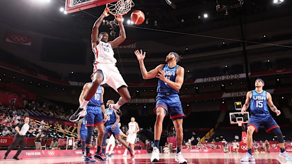 Moustapha Fall #93 of Team France dunks the ball over JaVale McGee #11 of Team United States. 