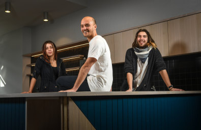 Jarrod Briffa, (centre), CEO of not-for-profit Kinfolk cafe, at its soon-to-open sister cafe, Sibling, in Carlton North. Pictured with Kinfolk volunteers Jaguar, left, and Sam Muller. 