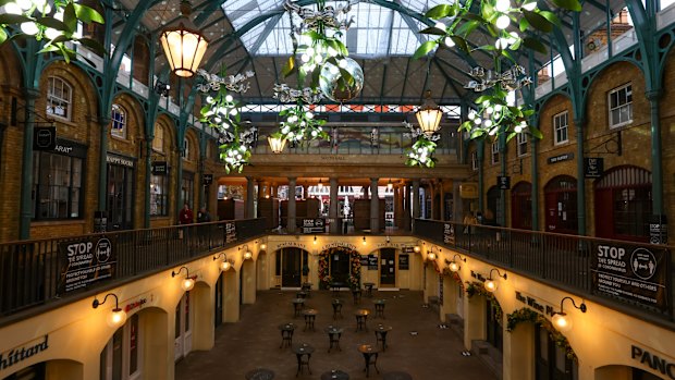 Festive decorations and closed shops in Covent Garden, London.