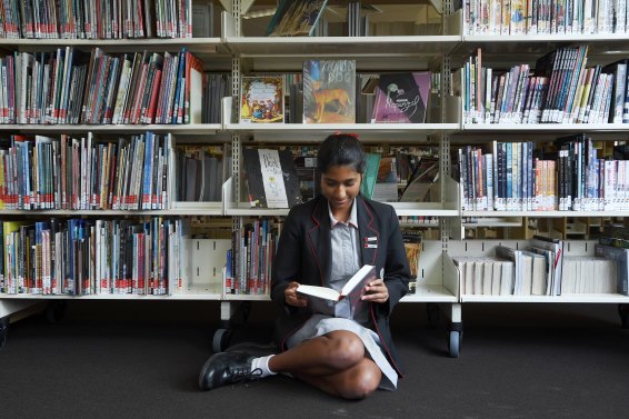 Amisha Guta, 16, reading in the library at Queenwood school in Mosman.