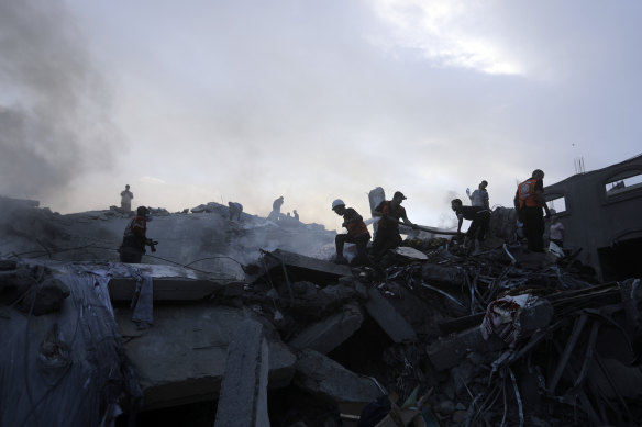 Palestinians look for survivors under rubble.