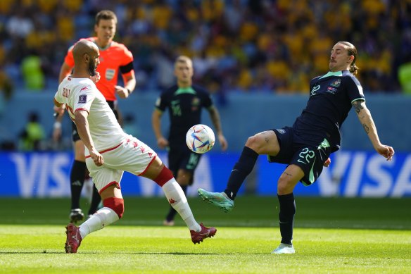 Jackson Irvine (right) tussles with Tunisia’s Issam Jebali.