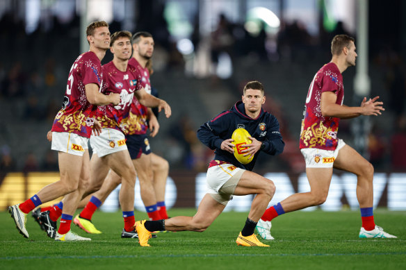 Dayne Zorko of the Lions warms up.