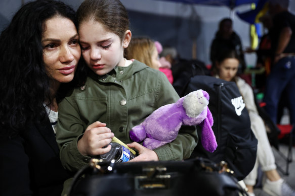 A Ukrainian mother and daughter, who are seeking asylum in the US, wait to cross the US-Mexico border at the San Ysidro Port of Entry amid the Russian invasion of Ukraine.