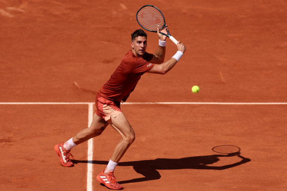 Thanasi Kokkinakis returns the ball to Stan Wawrinka during their second-round clash.