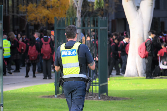 Police keep watch outside a western suburban school.