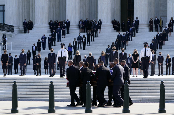 Dozens of Ginsburg's former clerks stood at attention when the coffin arrived at the courthouse.