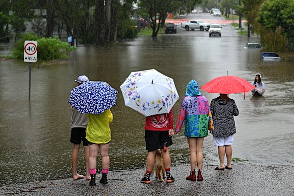Newmarket residents surveying floodwater on Edmondstone Street on March 9, the day before the city would record 275mm rainfalls from ex-tropical cyclone Alfred.