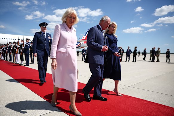 Queen Camilla, in a Dior coat dress, and King Charles arrive in the US.