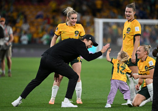 Tony Gustavsson high fives Tameka Yallop’s daughter Harley after Australia’s World Cup quarter-final win over France.
