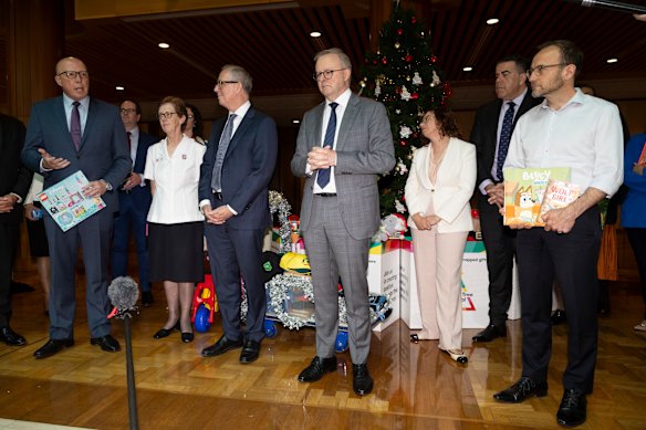 Peter Dutton (left), Anthony Albanese (centre) and Adam Bandt (right) at a wishing tree appeal event in 2023.