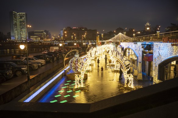 People walk through a Christmas alley in Moscow as the temperature hovers well above zero.