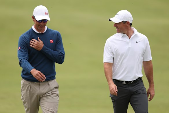 Adam Scott (left) and Rory McIlroy during the first round of the Australian Open.