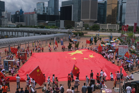 Beijing supporters display a Chinese flag to celebrate the 23rd anniversary of Hong Kong's return to Chinese rule and the new national security law in Hong Kong on Wednesday.