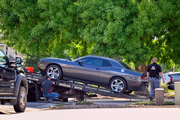 A Dodge is towed from Robinson’s family home.