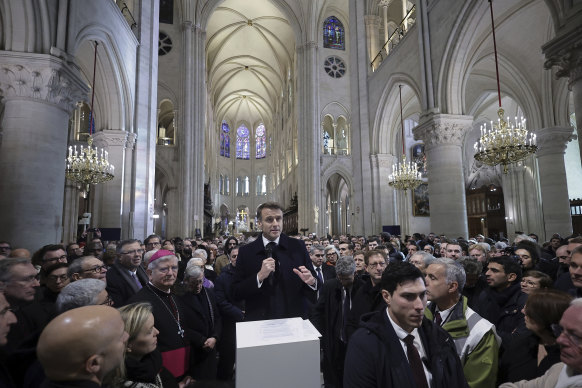 French President Emmanuel Macron delivers a speech inside Notre-Dame cathedral after visiting the restored interiors of the monument.