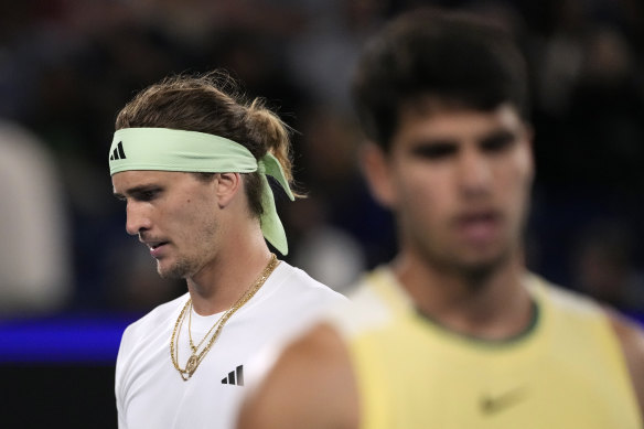 Alexander Zverev, left, of Germany walks behind Carlos Alcaraz of Spain.