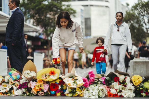 Mourners leave tributes outside the shopping centre in the heart of Bondi Junction on Sunday.