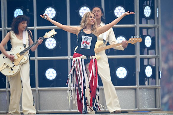 Rain be damned: Kylie Minogue rocks the ’G moments before the AFL grand final kicks off.