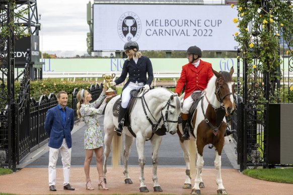 Damien Oliver and Jamie Kah hand the Melbourne Cup over to Ariane Titmus at Monday’s carnival launch.