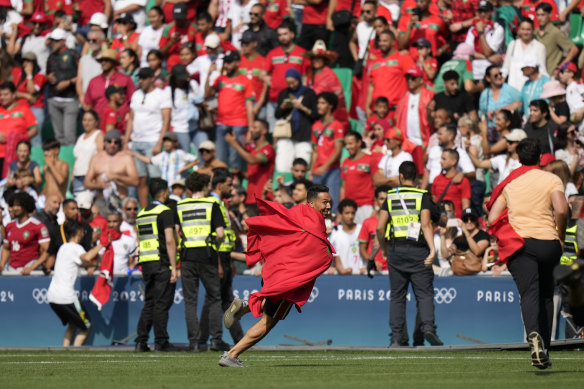 Fans of Morocco invade the pitch during the Men’s group B match between Argentina and Morocco.