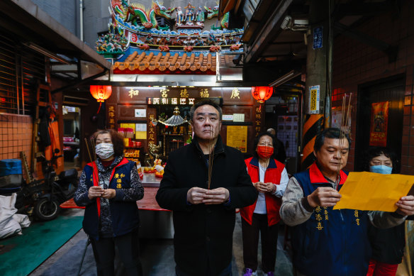Liang Tsu-wei (centre), a member of Taiwan’s Unionist Party, prays at his temple in Taipei.