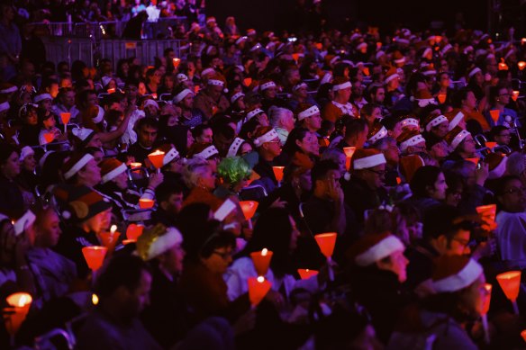 Families enjoying the Christmas spirit at Carols in the Domain last year. 