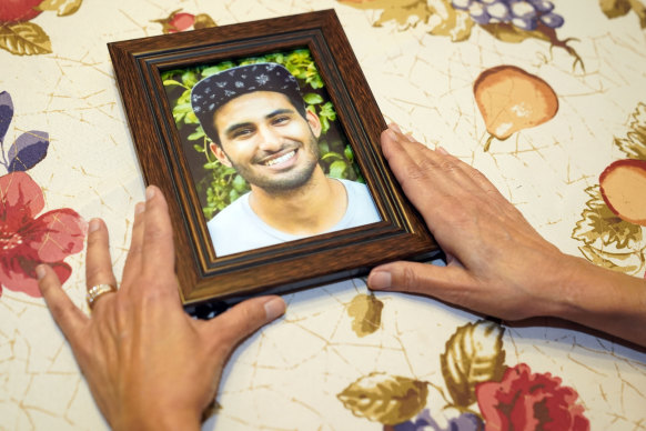 Dolores Cruz shows a photograph of her youngest son, Eric Cruz, at her home in San Gabriel, California. Cruz published an essay in 2022 about grieving for her son, who died in a car crash in 2017. 