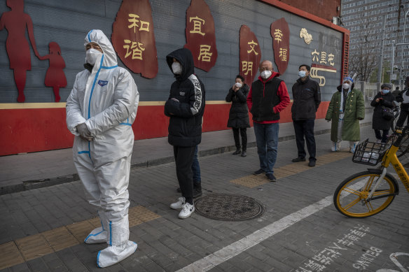 People in Beijing queue for a nucleic acid test. Attempts to ease strict zero-COVID rules have coincided with the worst outbreak in six months.